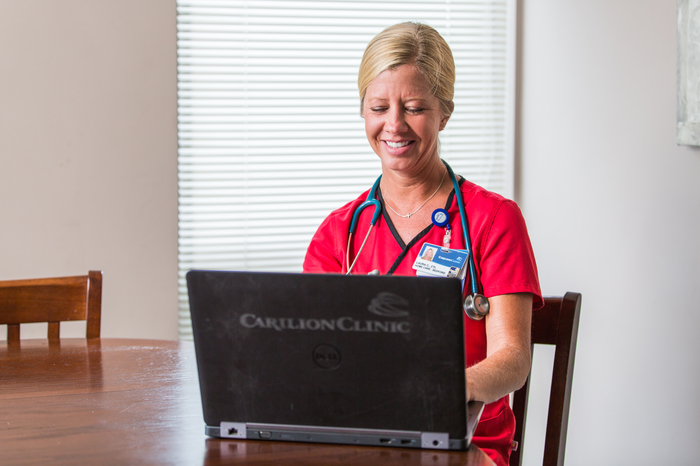 A Carilion nurse working on a Carilion branded laptop