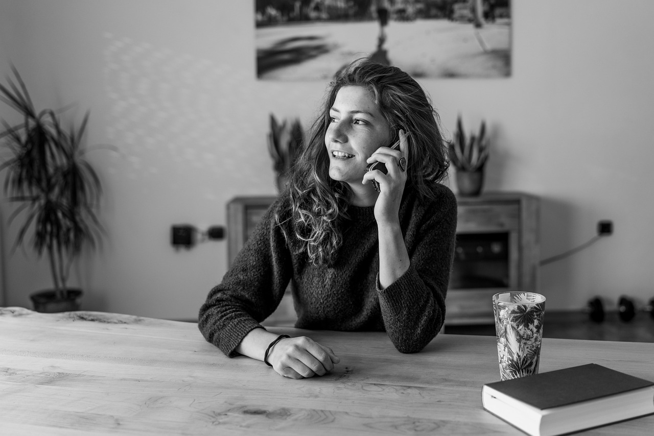 A person speaking on a phone call at home