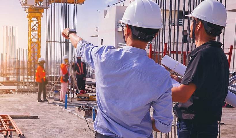 Site supervisors reviewing progress on a high rise build
