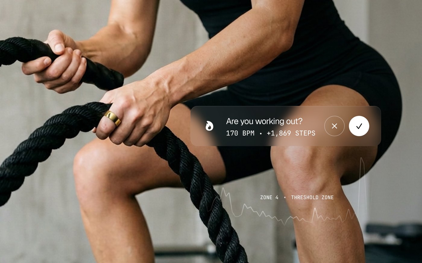 A Ring AIR wearer training with battle ropes with a workout detection prompt overlay